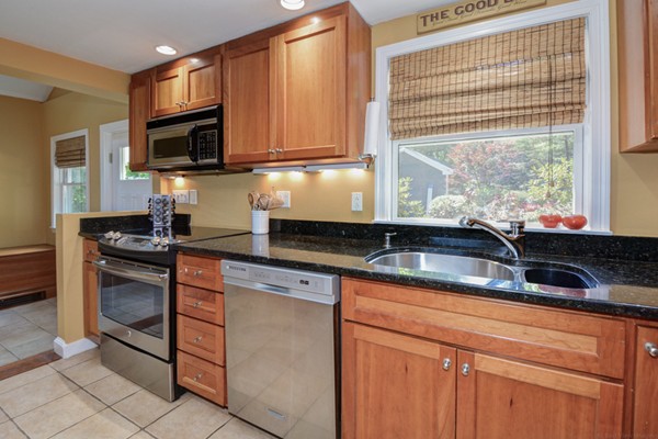 122 Barton Road Stow, MA 01775 - Photo 11 of 30 a kitchen with stainless steel appliances granite countertop a sink stove and microwave