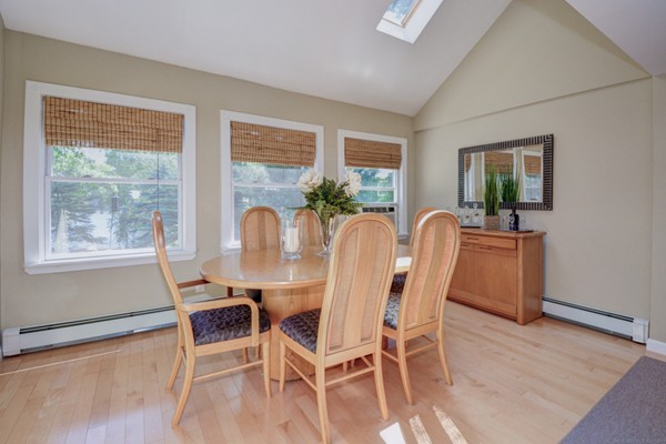 122 Barton Road Stow, MA 01775 - Photo 16 of 30 a view of a dining room with furniture wooden floor and a potted plant