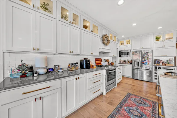 a kitchen with stainless steel appliances granite countertop a sink and cabinets