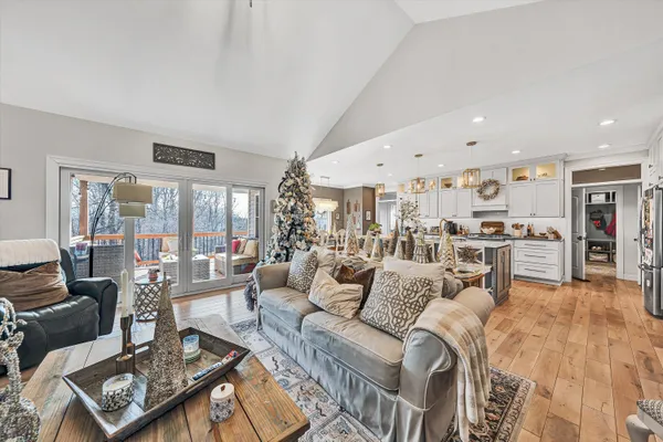 a living room with furniture and a view of kitchen