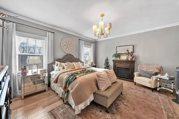 a bed room with a bed and a chandelier