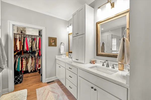 a en suite bathroom with a double vanity sink and a mirror