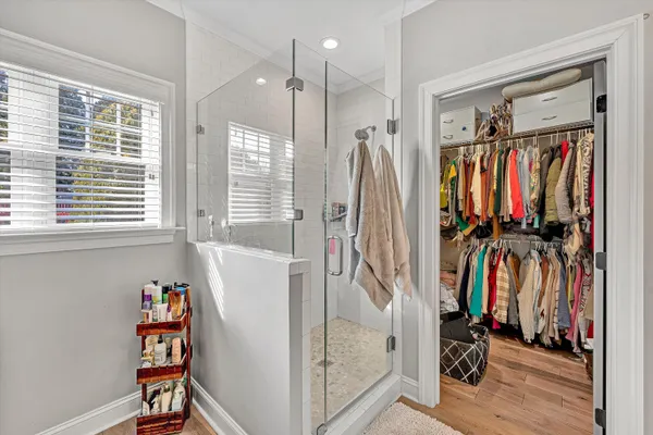 a view of walk in closet with clothes and shoes