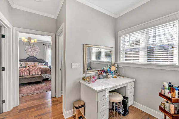 a view of a bedroom with furniture window and wooden floor