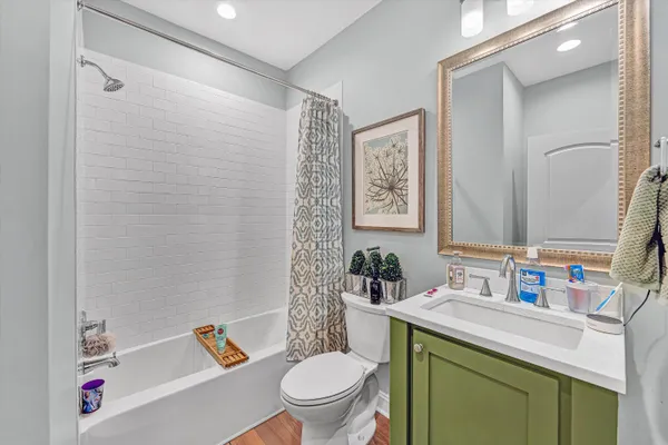 a bathroom with a sink toilet vanity and tub