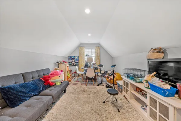 a living room with furniture a air conditioner vent and a window