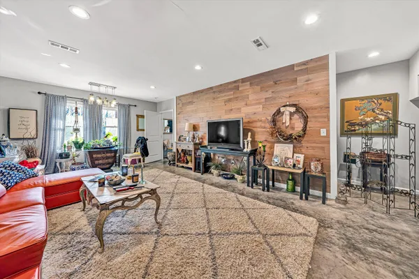 a living room with furniture a dining table and window view