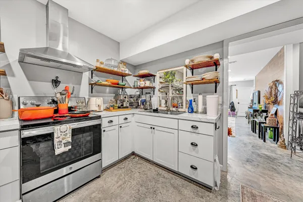 a kitchen with stainless steel appliances granite countertop a stove and cabinets