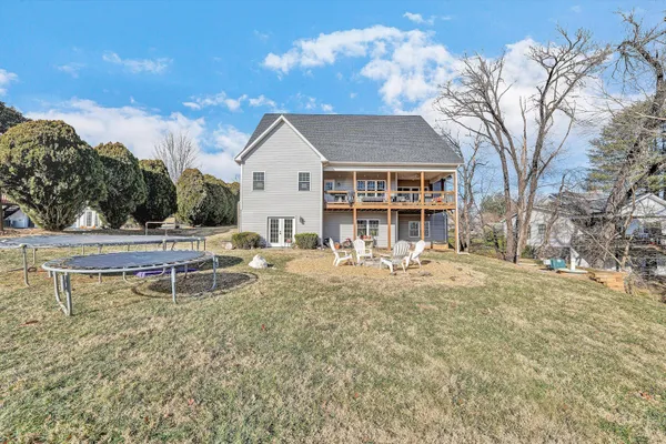 a view of a house with backyard porch and sitting area