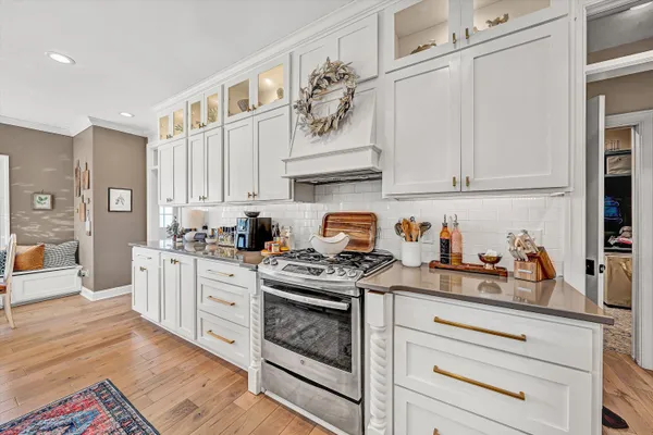 a kitchen with granite countertop white cabinets and white appliances
