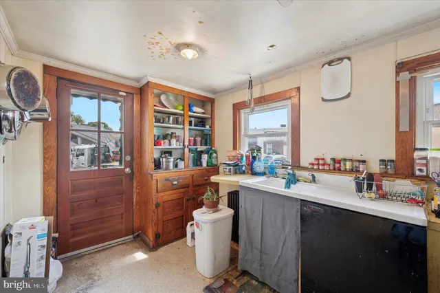 a kitchen with a sink cabinets and window