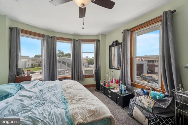 a bedroom with bed and a large window