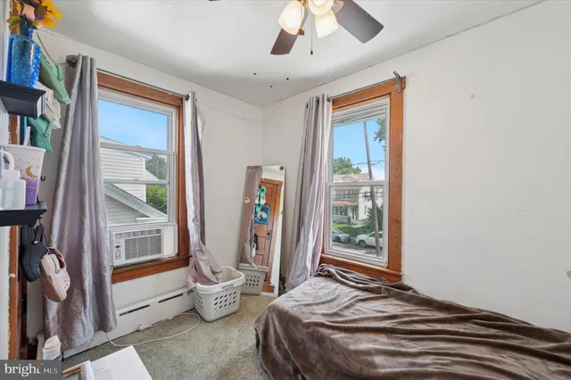 a bedroom with bed and wooden floor
