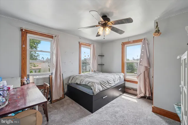 a spacious bedroom with a large bed and a chandelier