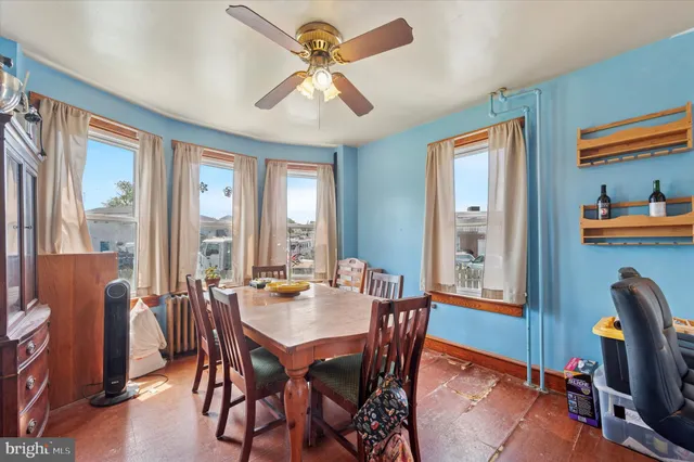 a dining room with furniture a window and a chandelier