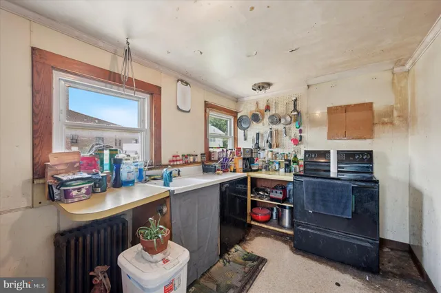 a room with furniture a sink a flat screen tv and a window