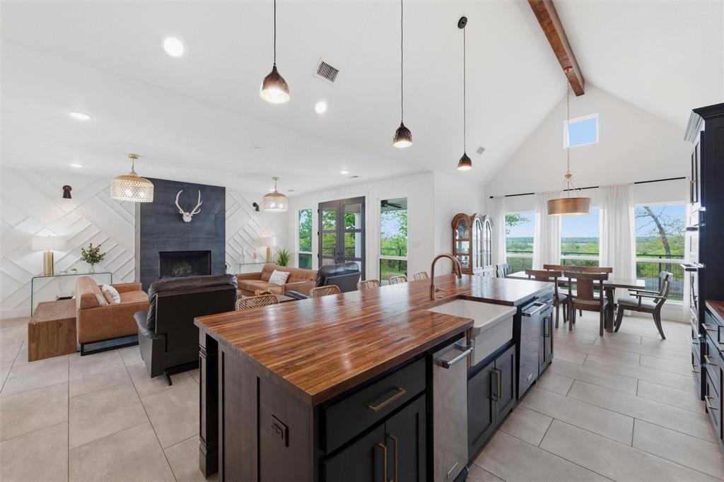 434 Sandstone Court Sunset, TX 76270 - Photo 12 of 40 a dining hall with stainless steel appliances granite countertop a dining table chairs and couches