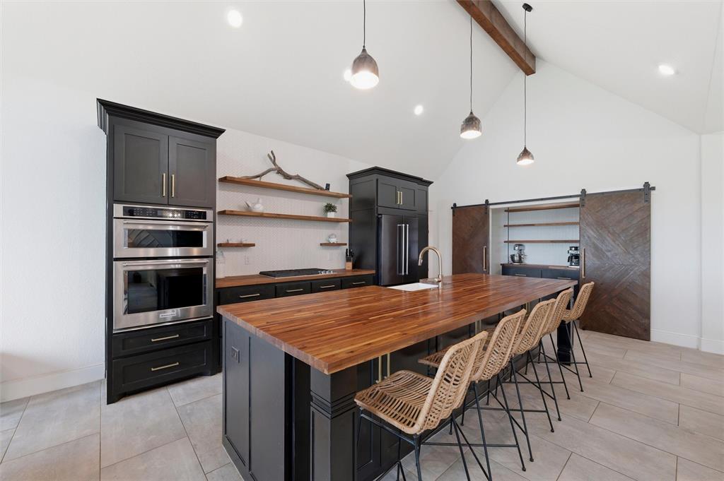 434 Sandstone Court Sunset, TX 76270 - Photo 14 of 40 a kitchen with a table and chairs in it