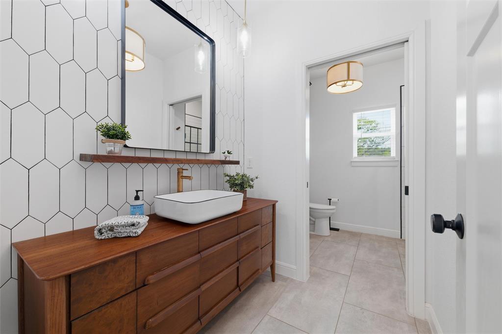 434 Sandstone Court Sunset, TX 76270 - Photo 28 of 40 a bathroom with a sink a toilet and mirror