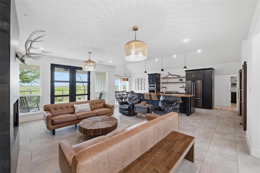 434 Sandstone Court Sunset, TX 76270 - Photo 6 of 40 a living room with furniture kitchen view and large windows