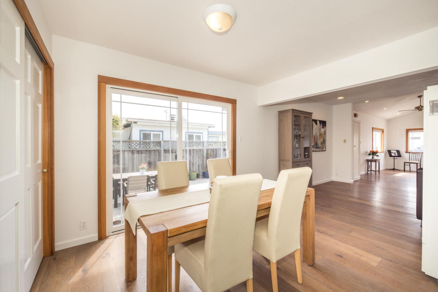 365 Spruce Street Half Moon Bay, CA 94019 - Photo 15 of 34 a view of a dining room with furniture and wooden floor
