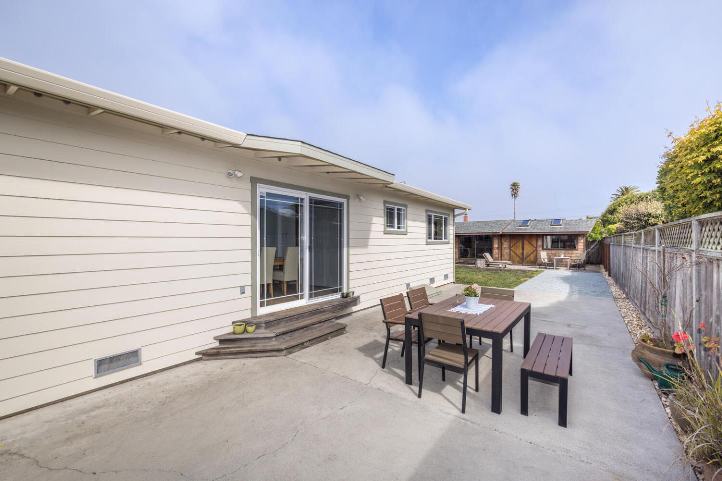 365 Spruce Street Half Moon Bay, CA 94019 - Photo 25 of 34 a view of a patio with table and chairs and wooden fence