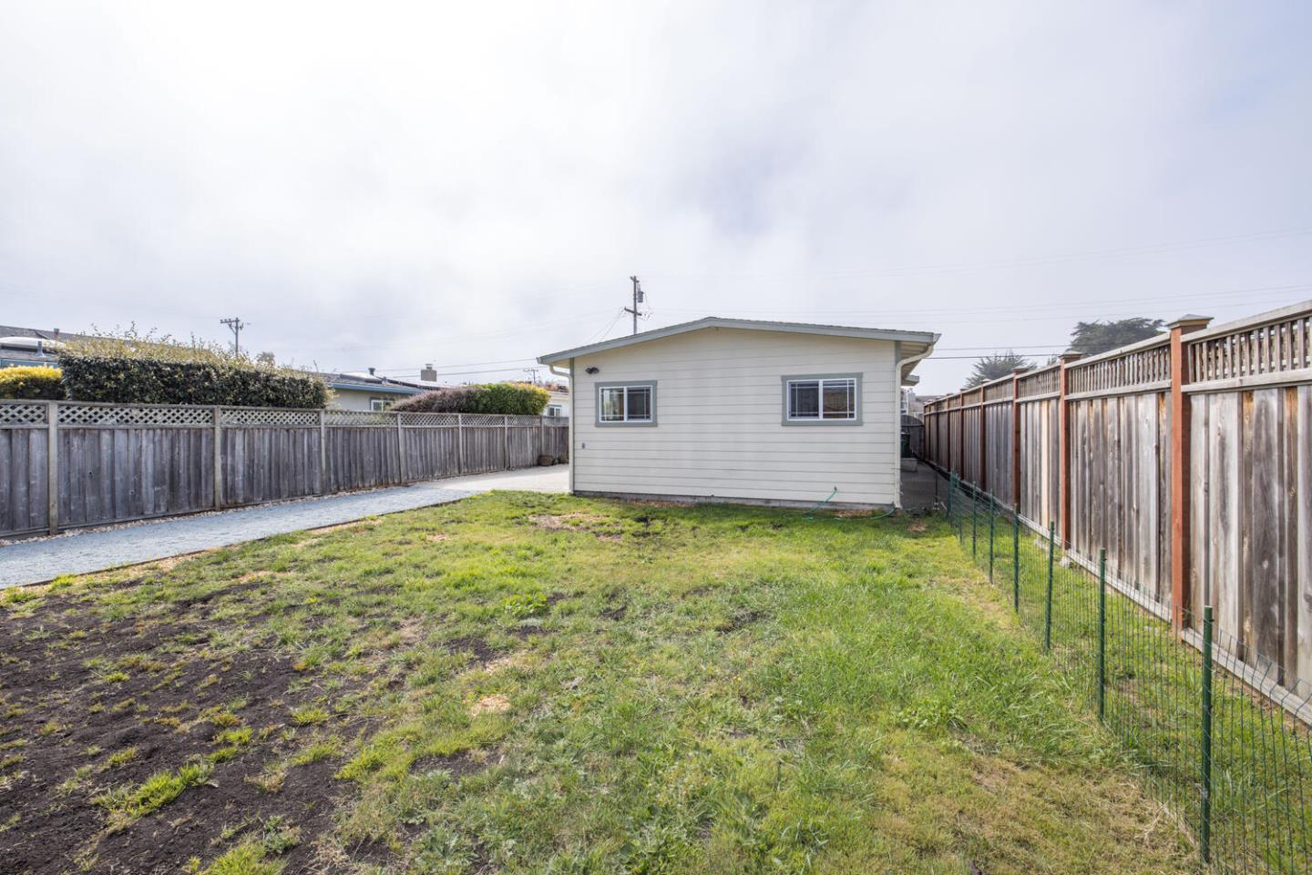 365 Spruce Street Half Moon Bay, CA 94019 - Photo 30 of 34 a view of a backyard with wooden fence