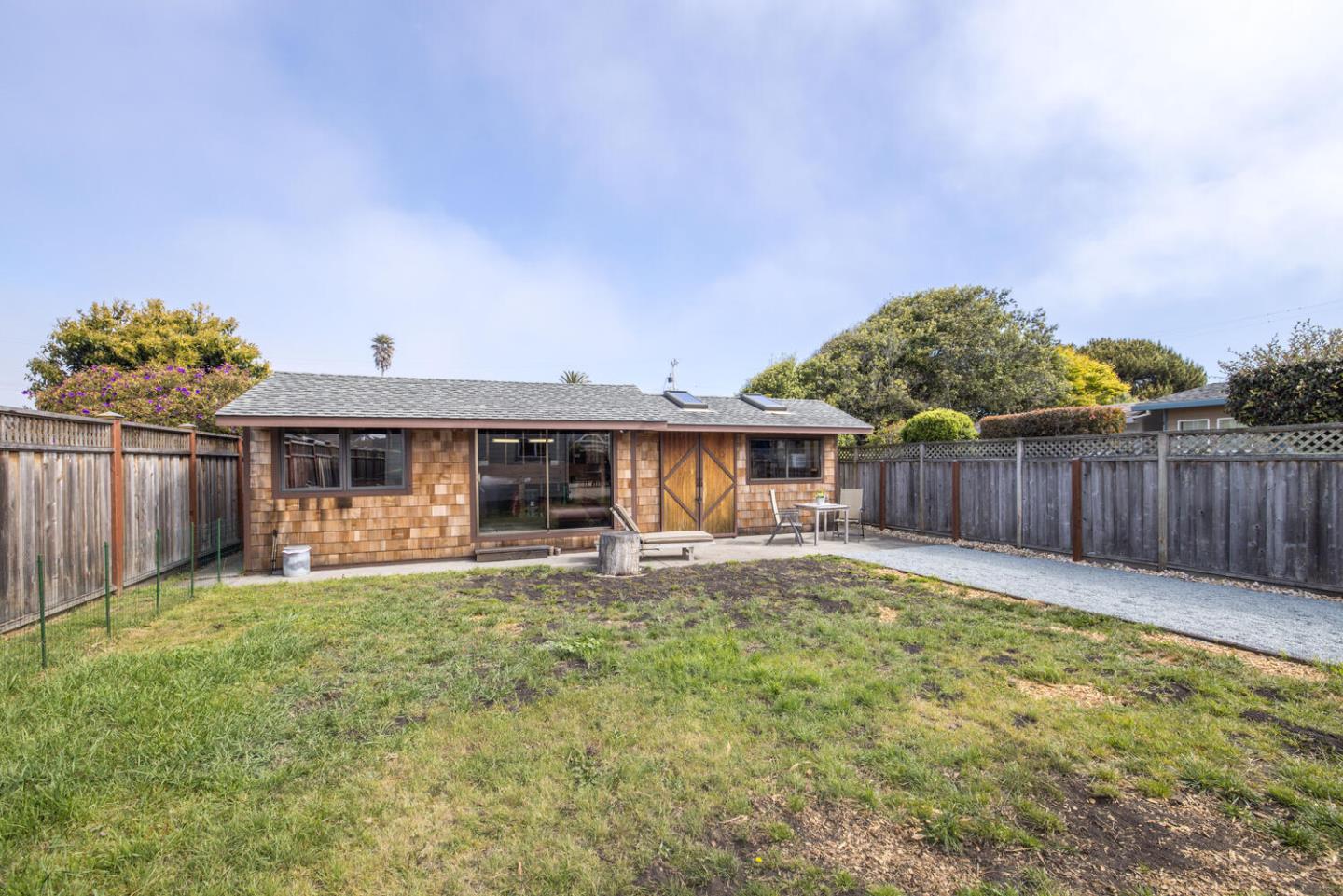 365 Spruce Street Half Moon Bay, CA 94019 - Photo 32 of 34 a front view of house with yard and trees in the background