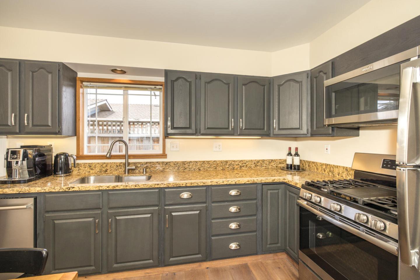 365 Spruce Street Half Moon Bay, CA 94019 - Photo 4 of 34 a kitchen with stainless steel appliances granite countertop a sink stove and microwave