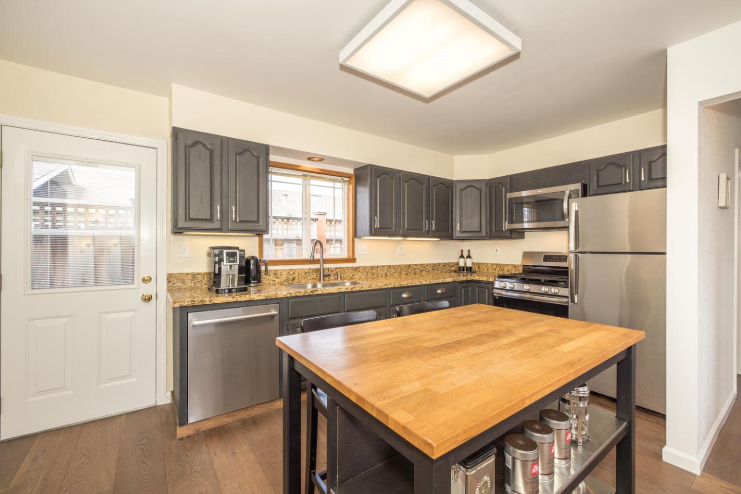 365 Spruce Street Half Moon Bay, CA 94019 - Photo 6 of 34 a kitchen with stainless steel appliances granite countertop a refrigerator a sink and a stove
