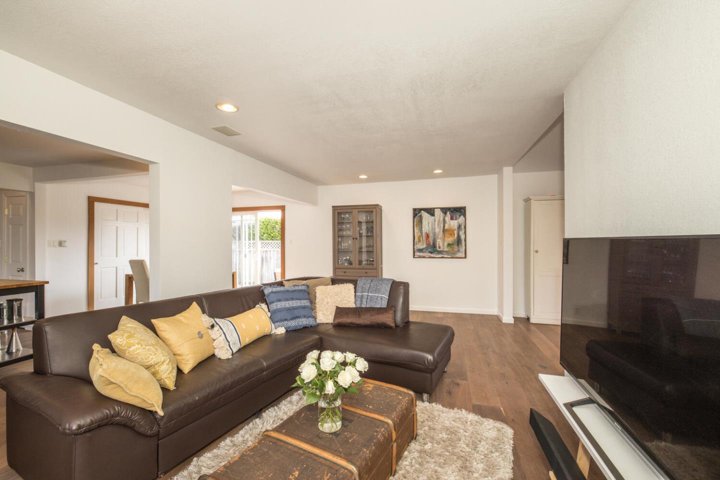 365 Spruce Street Half Moon Bay, CA 94019 - Photo 9 of 34 a living room with furniture and a flat screen tv