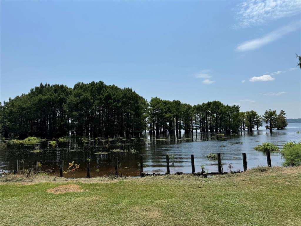 1214 C C Sandidge Road Elm Grove, LA 71051 - Photo 2 of 3 a view of a swimming pool with an outdoor space and seating area