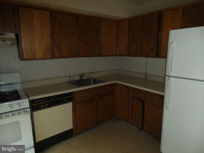 7953 Riggs Road, Unit 79532 Hyattsville, MD 20783 - Photo 3 of 10 a kitchen with a cabinets and a stove top oven