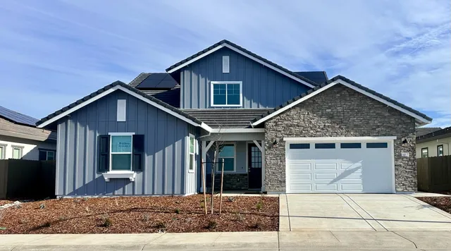 a front view of a house with yard