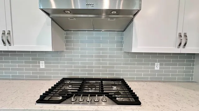 a bathroom with a granite countertop sink and a stove