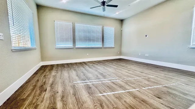 a large white kitchen with kitchen island a stove a sink dishwasher and a oven with white cabinets