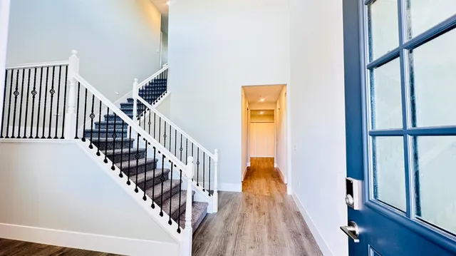 a view of entryway and hall with wooden floor
