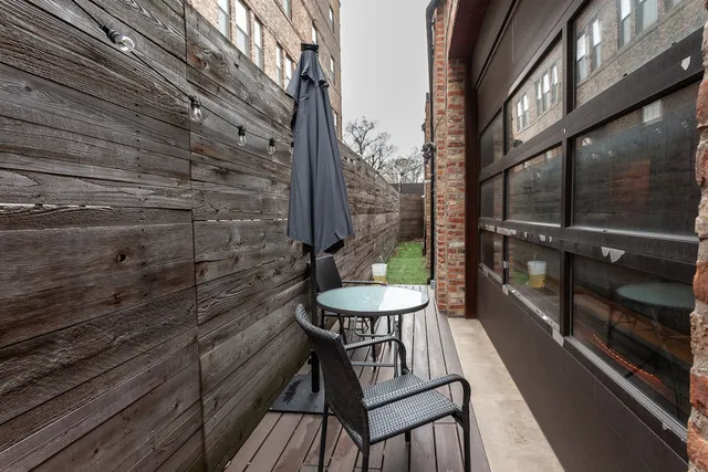 a view of a balcony with chairs and table