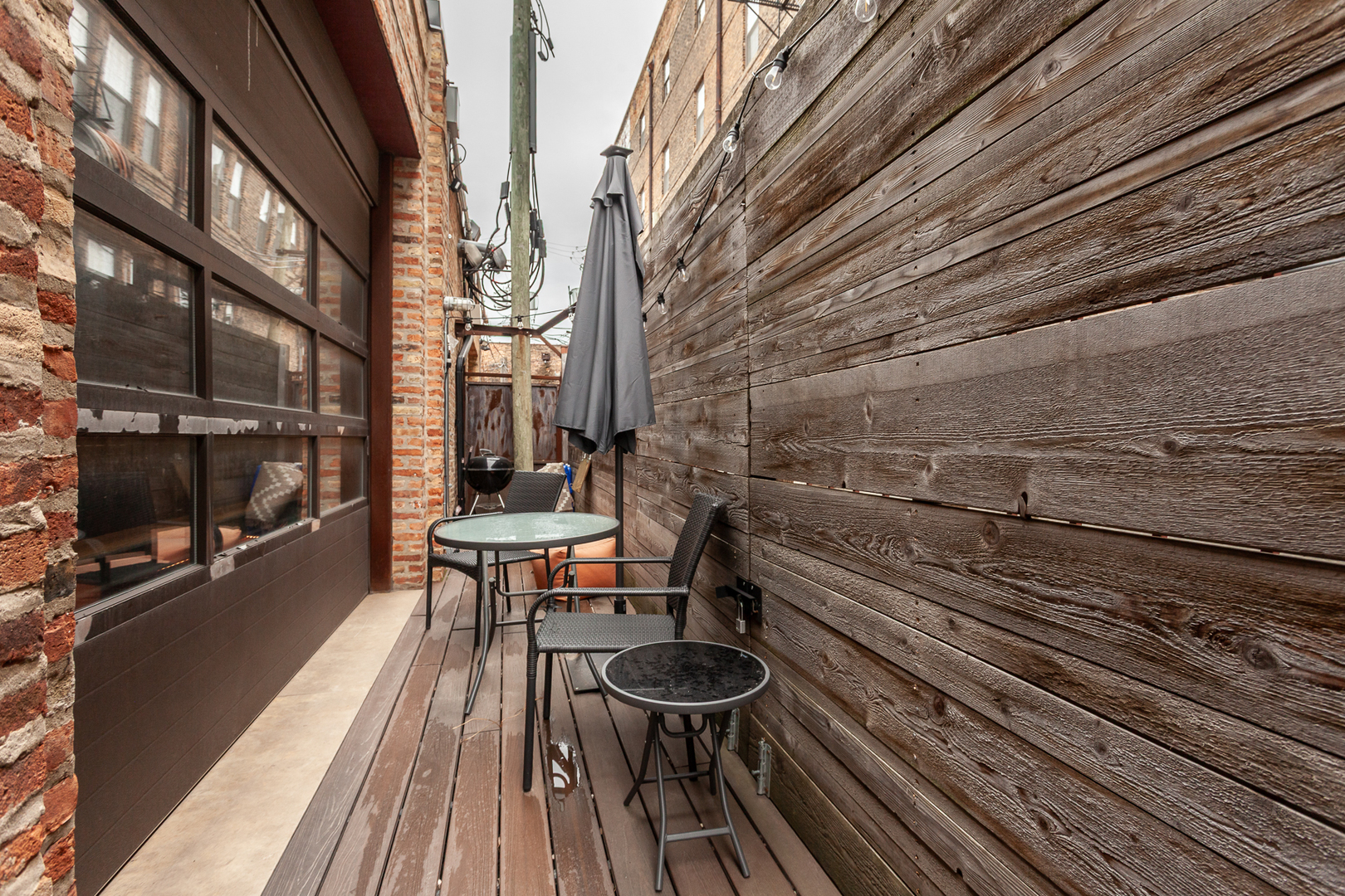 2425 West 14th Street Chicago, IL 60608 - Photo 12 of 27 a view of a balcony with chairs and wooden floor