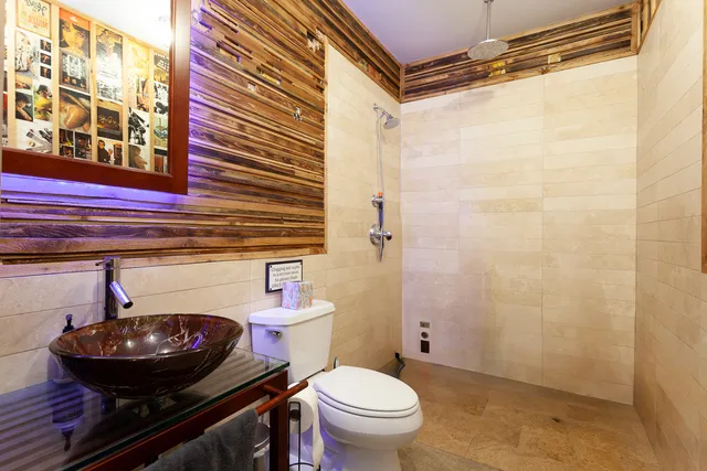 a bathroom with a toilet and a mirror