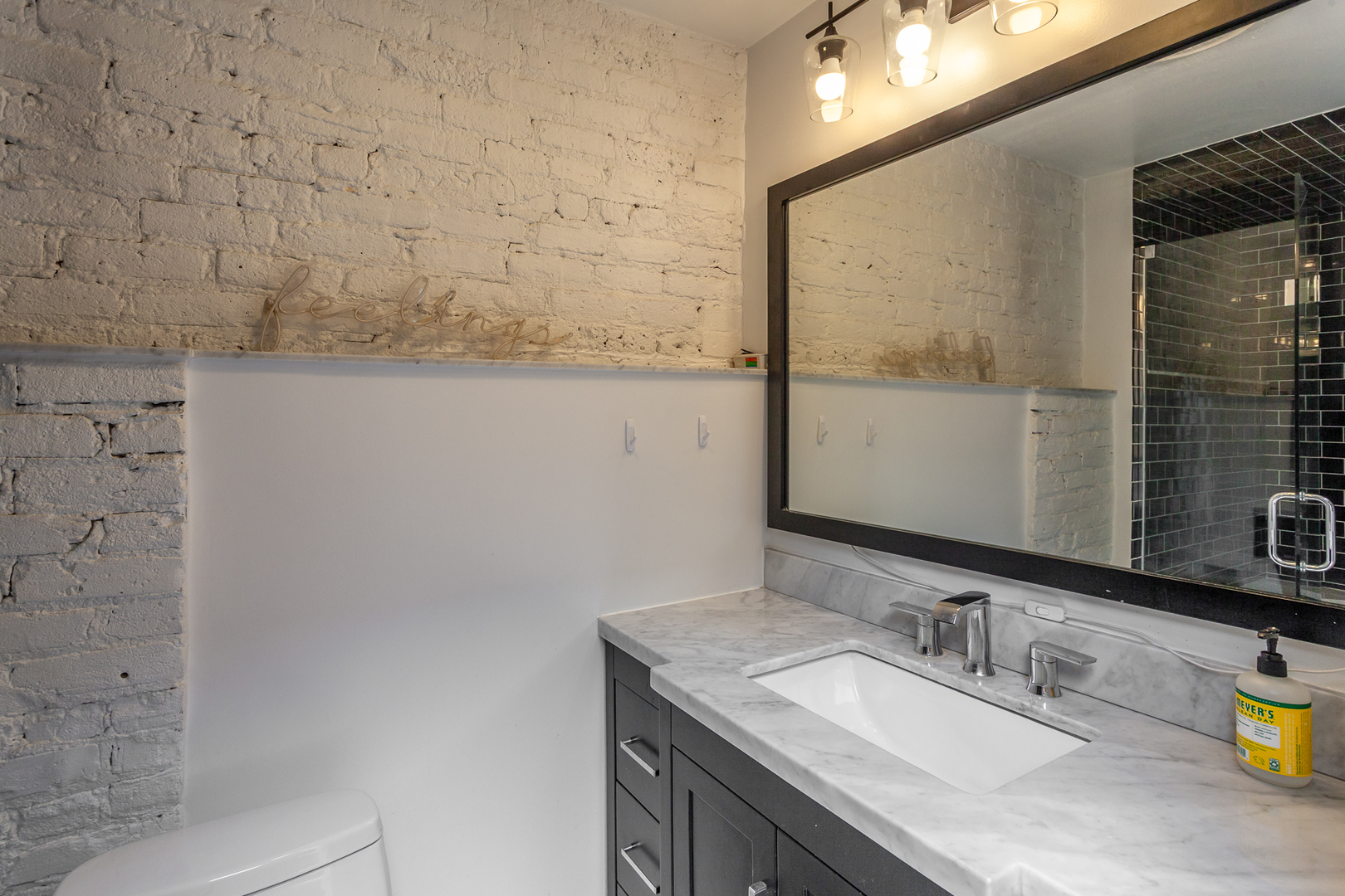2425 West 14th Street Chicago, IL 60608 - Photo 23 of 27 a bathroom with a granite countertop sink and a mirror