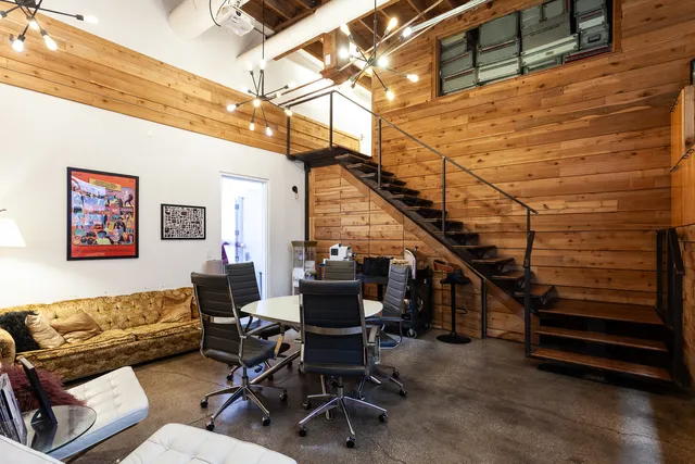 a living room with furniture and a ceiling fan