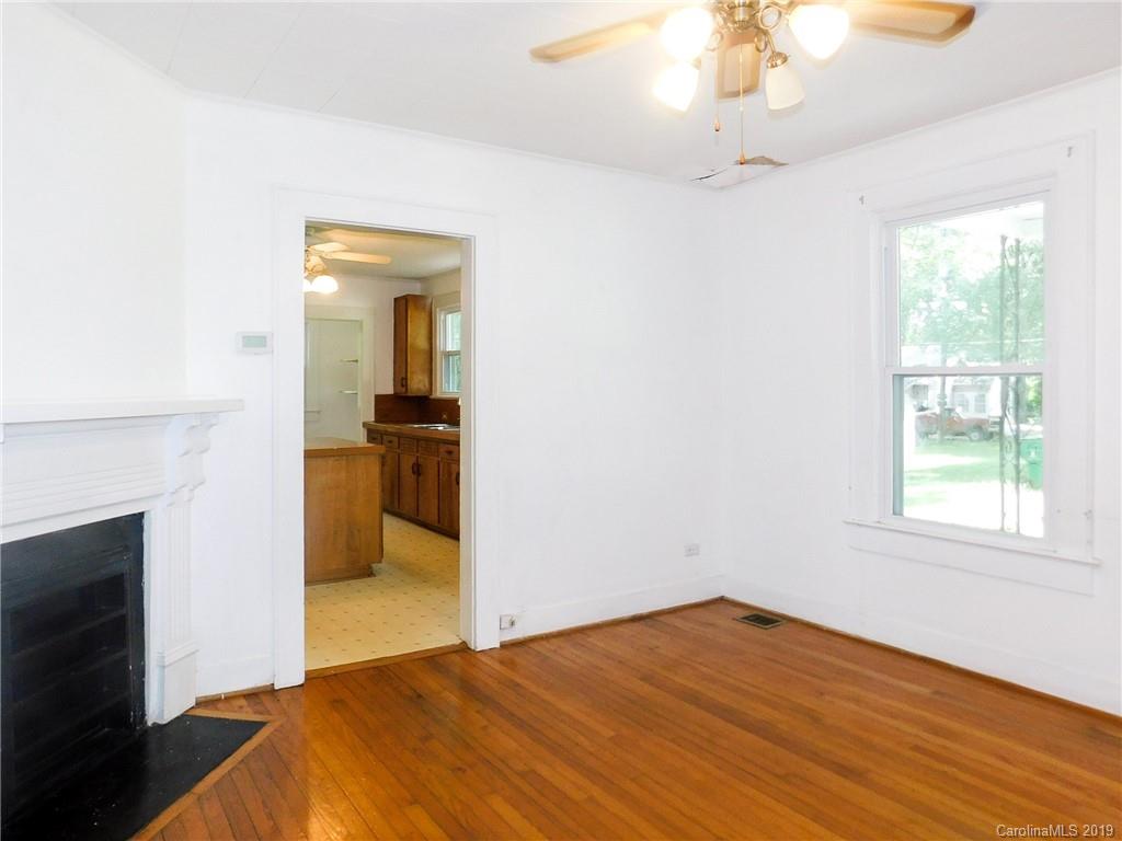 6201 Rumple Road Charlotte, NC 28262 - Photo 2 of 22 a bedroom with a bed and a chandelier