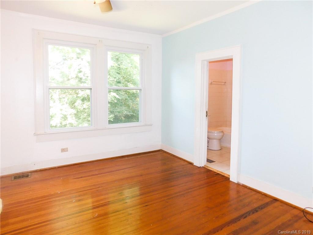 6201 Rumple Road Charlotte, NC 28262 - Photo 13 of 22 an empty room with wooden floor and windows