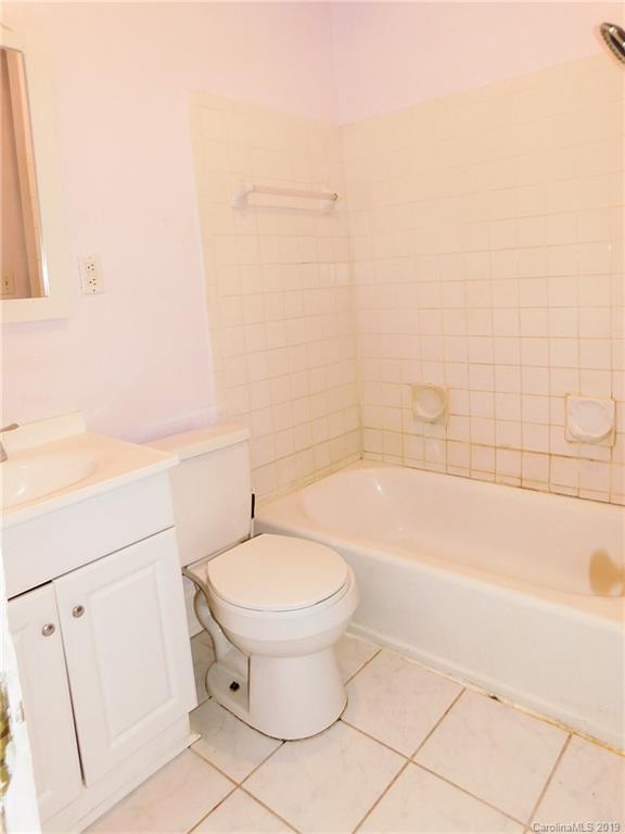 6201 Rumple Road Charlotte, NC 28262 - Photo 15 of 22 a bathroom with a sink a toilet and bathtub
