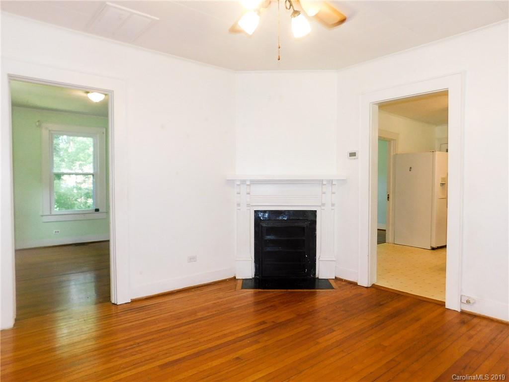 6201 Rumple Road Charlotte, NC 28262 - Photo 3 of 22 a view of empty room with wooden floor and fireplace