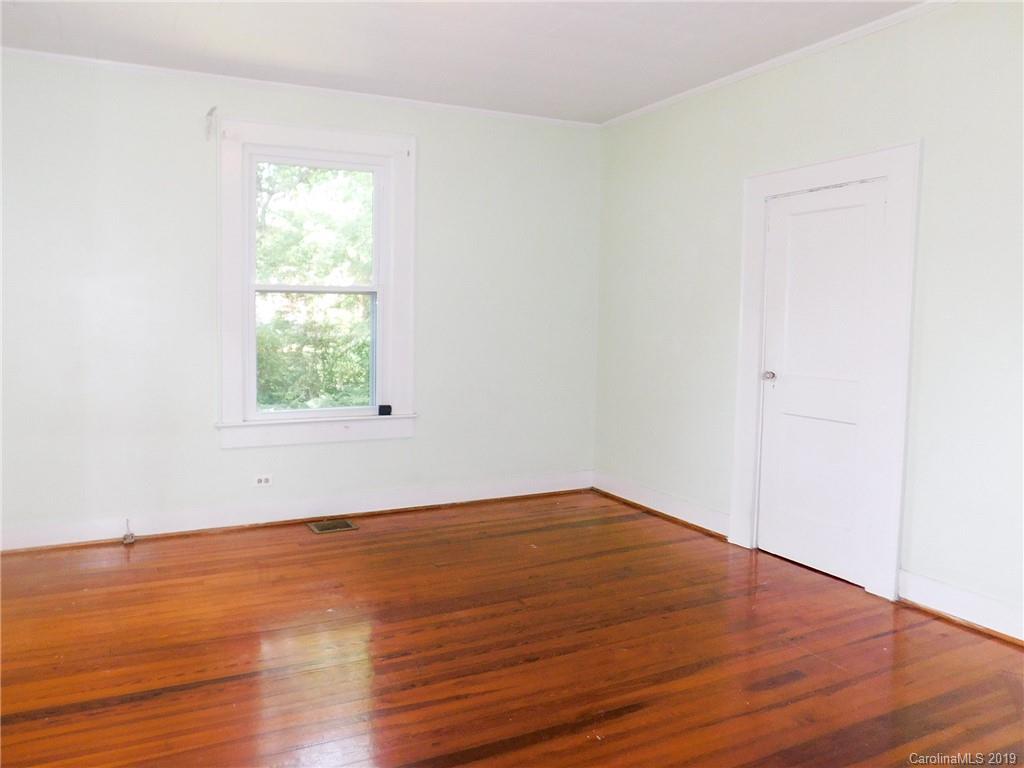 6201 Rumple Road Charlotte, NC 28262 - Photo 5 of 22 an empty room with wooden floor and windows