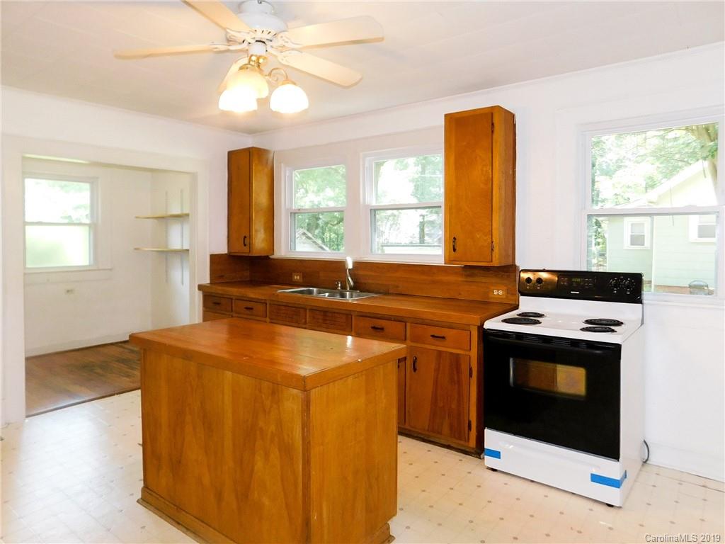 6201 Rumple Road Charlotte, NC 28262 - Photo 7 of 22 a kitchen with stainless steel appliances granite countertop a sink stove and refrigerator
