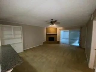 a view of empty room with a fireplace