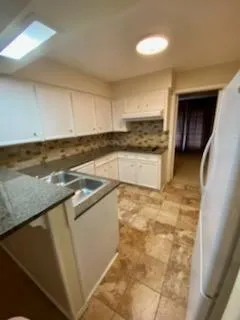 a kitchen with stainless steel appliances granite countertop a sink and a stove